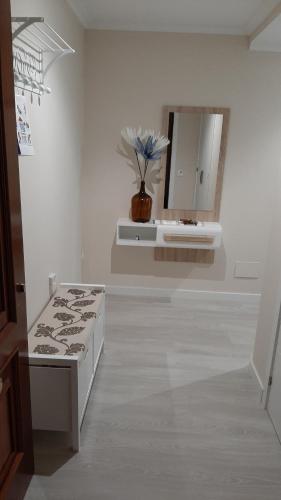 a white room with a sink and a mirror at Vial Sol in Viveiro