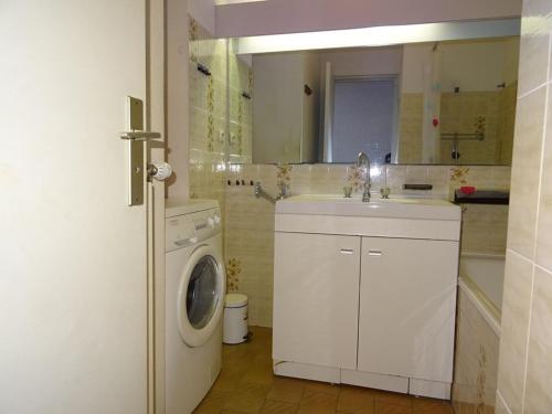 une salle de bain avec une machine à laver et un lavabo dans l'établissement Palavas F2 cabine dernier étage, double terrasse, parking privé - FR-1-559-22, à Palavas-les-Flots