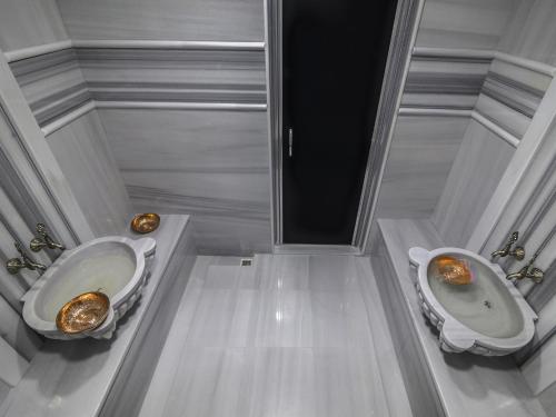 a bathroom with two toilets and a bidet at Fesa Business Hotel in Gebze
