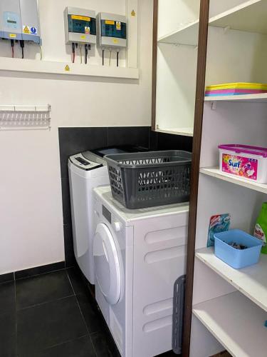 a laundry room with a washing machine and a washer at Villa Tiki - wonderfull sea view in Punaauia