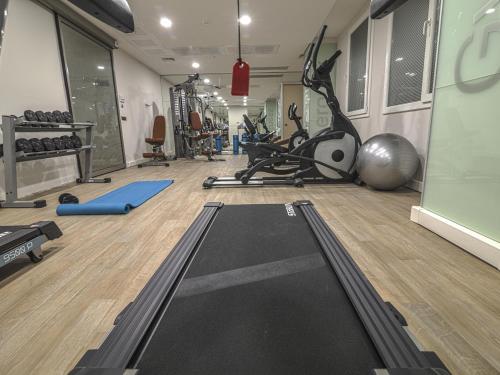 a gym with a treadmill and exercise equipment in a room at Fesa Business Hotel in Gebze