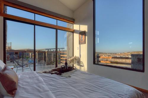 a bedroom with a bed and a large window at Sirius Valle in Valle de Guadalupe