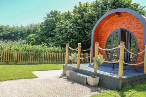 a small gazebo in a yard with a fence at Filbert Pod in Arundel