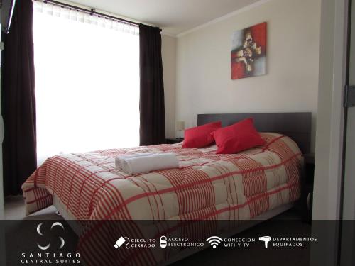 a bedroom with a bed with red pillows and a window at Santiago Central Suites / Mapocho in Santiago