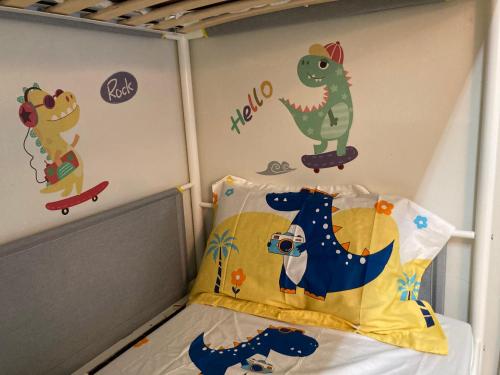 a childs bedroom with dinosaur stickers on the wall at YHA Ngong Ping SG Davis Youth Hostel in Hong Kong