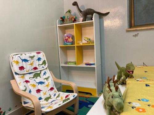 a childs room with a chair and a bed and a shelf at YHA Ngong Ping SG Davis Youth Hostel in Hong Kong