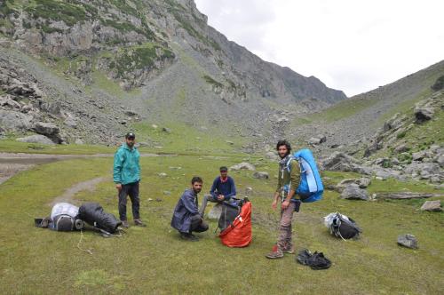 a group of people standing on a grassy hill at Kashmir Outlook Adventures in Pahalgām