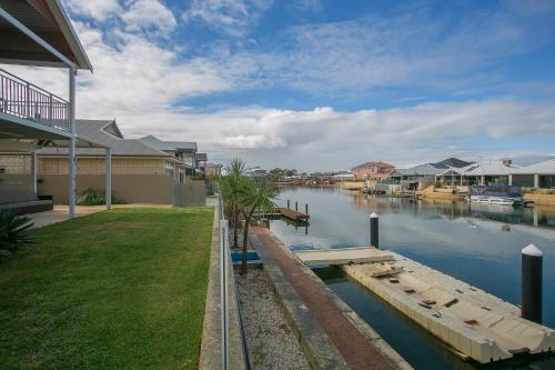 a view of a river with houses and a dock at "WATERLILY HOUSE" - Luxury Canal House, Jetty, Dog & Child Friendly - Sleeps 14 in Mandurah