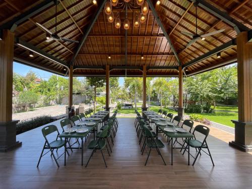 a group of tables and chairs in a pavilion at The Valerian Villa Ubud in Ubud