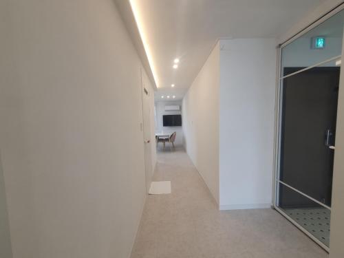 a hallway with a glass door in a building at Mr. Slow in Sokcho