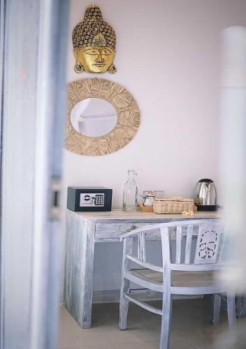 a white table with a mirror and a table with a chair at Salt Resort & Spa in Amed
