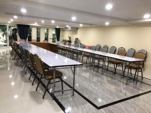 a row of tables and chairs in a conference room at The Lux Ladprao 10 in Bangkok