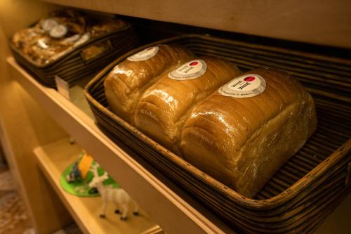 three loafs of bread sitting on a shelf at Poiisse in Kolkata