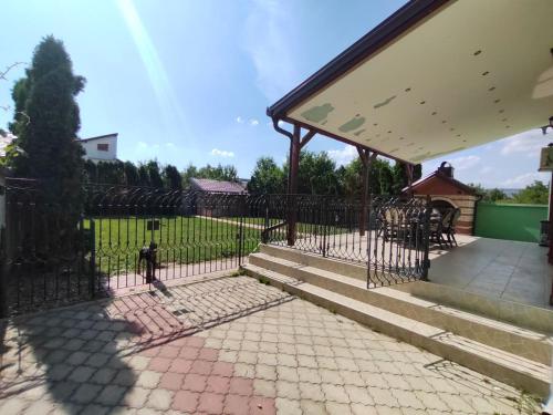 a wrought iron fence with stairs and a patio at Guest House Maja in Novi Sad
