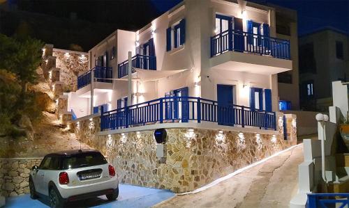 a car parked in front of a building at night at Meraki Beachfront in Foinikion