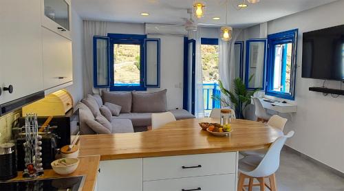 a kitchen and living room with a table and a couch at Meraki Beachfront in Foinikion