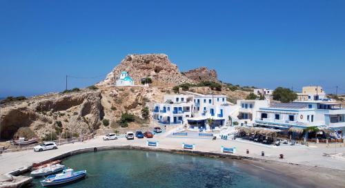 a view of a town with blue and white buildings at Meraki Beachfront in Foinikion