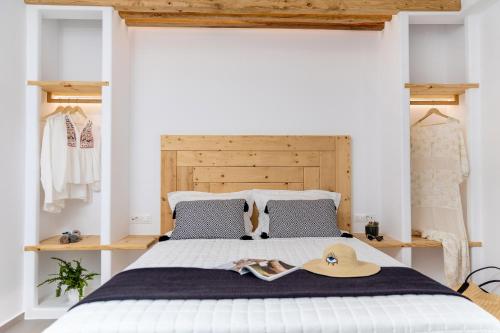 a bedroom with a bed with a hat on it at Alenor City Hotel in Naxos Chora