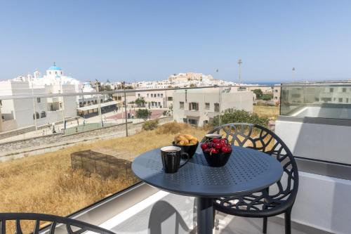 a table with two bowls of fruit on a balcony at Alenor City Hotel in Naxos Chora
