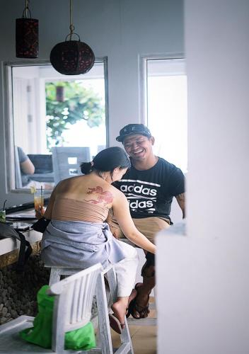 a man and a woman sitting in a barber shop at Salt Resort & Spa in Amed