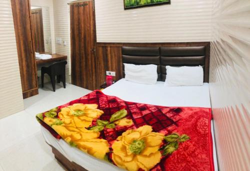 a bedroom with a bed with flowers on it at Jasneet Homestay in Amritsar