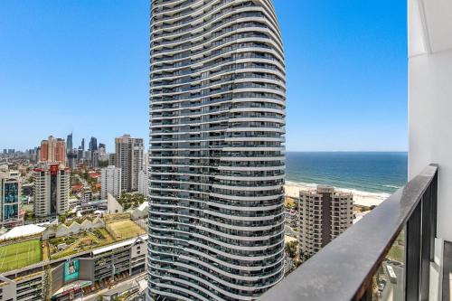 a tall building on the beach with the ocean at Koko Broadbeach in Gold Coast