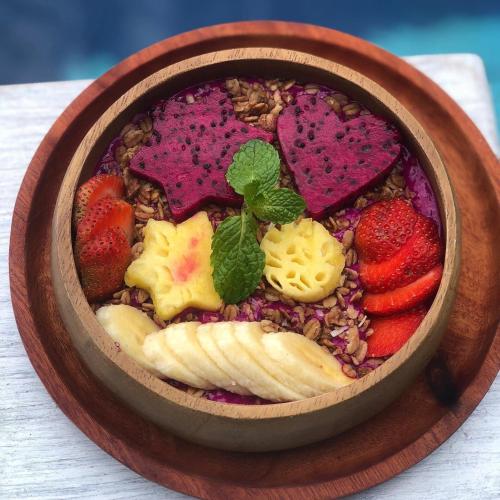 a bowl of food with fruit and vegetables at Salt Resort & Spa in Amed
