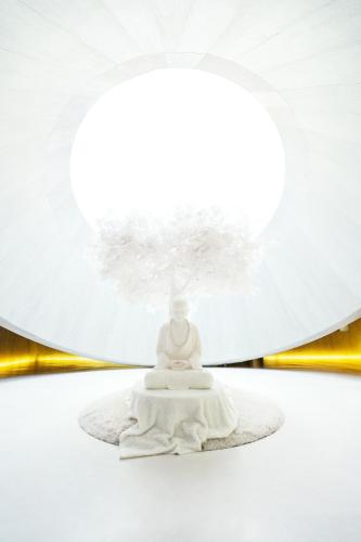 a buddha statue in front of a white umbrella at Holiday Inn - Nanjing South Station by IHG in Nanjing