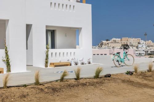 a bike parked on a sidewalk in front of a building at Alenor City Hotel in Naxos Chora