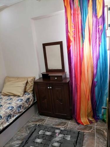a room with a curtain and a bed and a mirror at Sea spirit in Alexandria