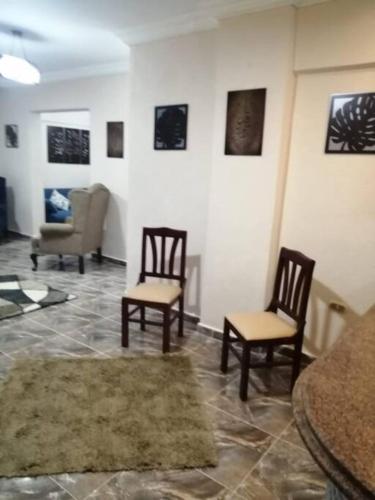a living room with two chairs and a table at Sea spirit in Alexandria
