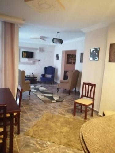 a living room with a table and chairs and a living room at Sea spirit in Alexandria