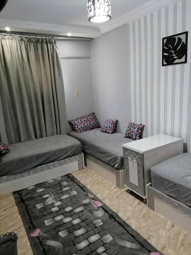 a living room with two beds and a tv at Sea spirit in Alexandria