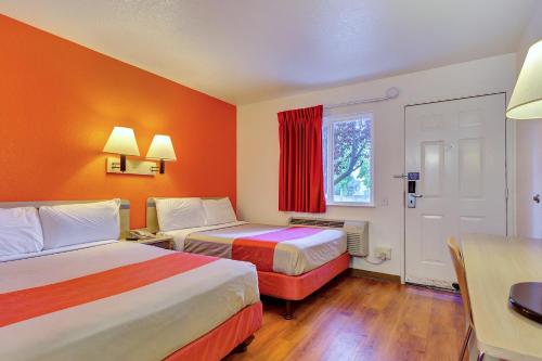 a hotel room with two beds and a table at Motel 6-Rohnert Park, CA in Rohnert Park