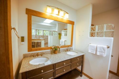 un bagno con due lavandini e un grande specchio di Hilo Vacation Rental a Hilo