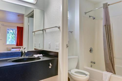 a bathroom with a sink and a toilet and a mirror at Motel 6-Rohnert Park, CA in Rohnert Park