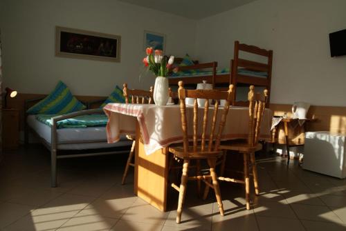 a dining room with a table and chairs and a couch at Dom Sonia in Niechorze