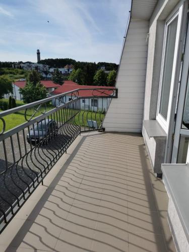 a balcony with a view of a house at Dom Sonia in Niechorze