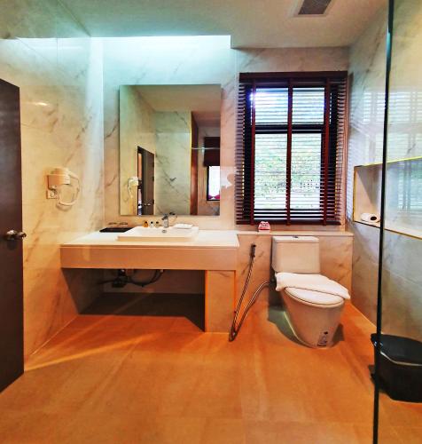 a bathroom with a toilet and a sink at Rnana Grand in Phangnga