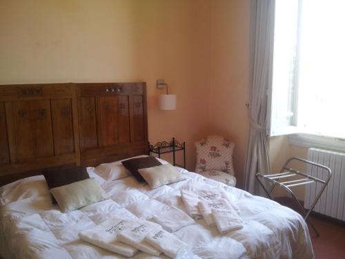 a bedroom with a bed with white sheets and pillows at Sangaggio House B&B in Florence