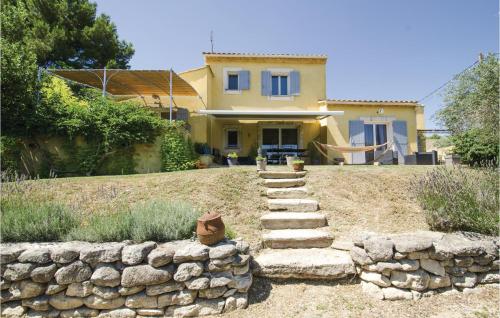 a house with a stone retaining wall and a staircase at Amazing Home In Caumont Sur Durance in Caumont-sur-Durance