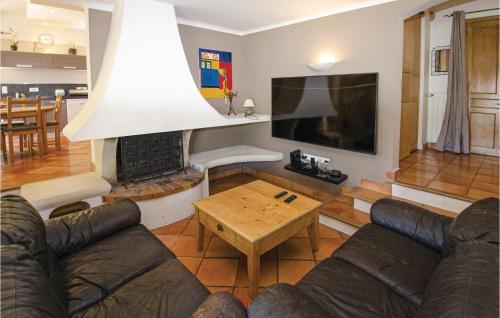 a living room with a couch and a fireplace at Amazing Home In Caumont Sur Durance in Caumont-sur-Durance