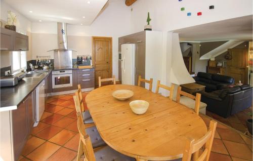 a kitchen with a wooden table in a kitchen at Amazing Home In Caumont Sur Durance in Caumont-sur-Durance