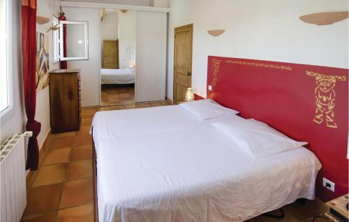 a bedroom with a white bed with a red headboard at Amazing Home In Caumont Sur Durance in Caumont-sur-Durance