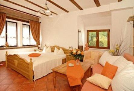 a large room with a bed and a couch at L´Antica Ruota - Zum Alten Wasserrad in Annweiler am Trifels