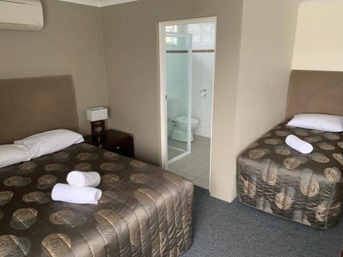 Ein Bett oder Betten in einem Zimmer der Unterkunft Titania Motel