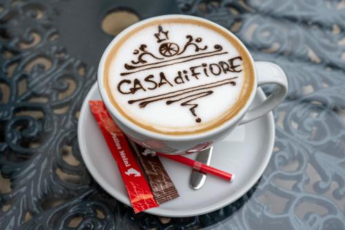 a cup of coffee on a plate on a table at Casa di Fiore SPA and Medical Hotel, Mineral Pools & Private Beach in Kranevo