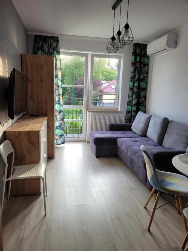 a living room with a couch and a table at Pensjonat Markus Grzybowo in Grzybowo