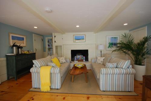 a living room with two couches and a fireplace at Chatham Seafarer Inn in Chatham