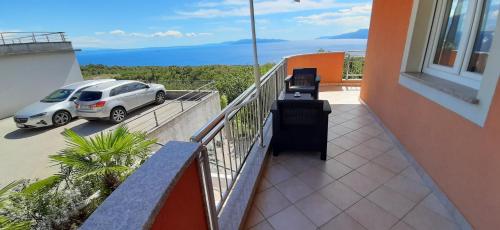 a balcony with a car parked on a building at Apartman Kos in Zamet